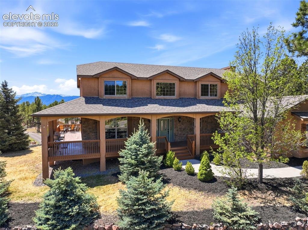 Image 1 of 50: Two-story residence featuring a covered front porch, stone accents, and dor