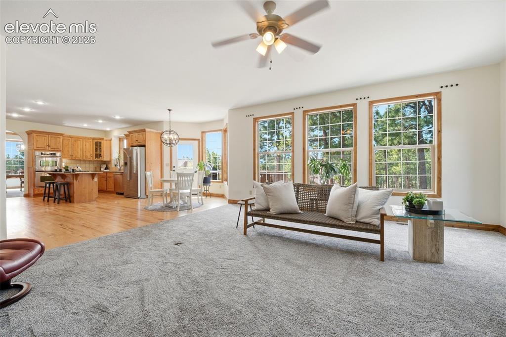 Image 10 of 50: Dining area featuring a tray ceiling with wood trim, a contemporary geometr