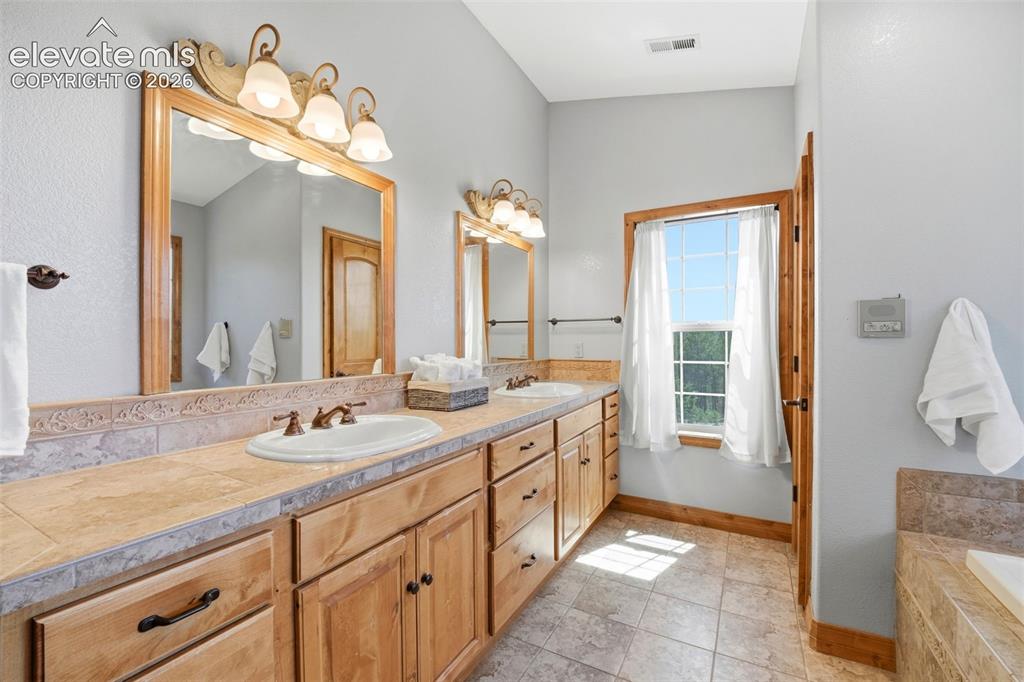 Image 15 of 50: Spacious room featuring vaulted ceilings, a ceiling fan, and light gray car