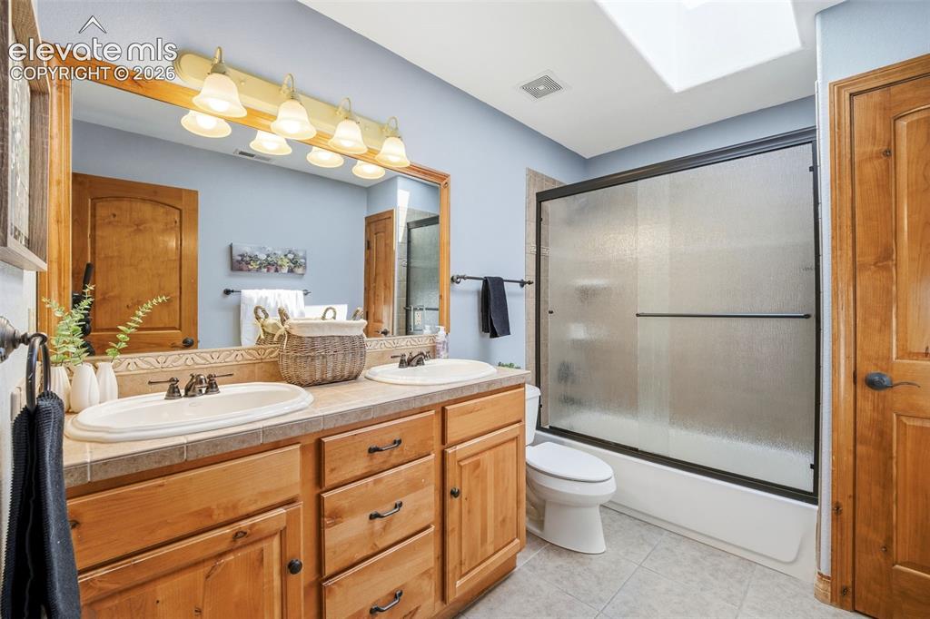 Image 20 of 50: Light-toned wall paint throughout, complemented by a ceiling fan with integ