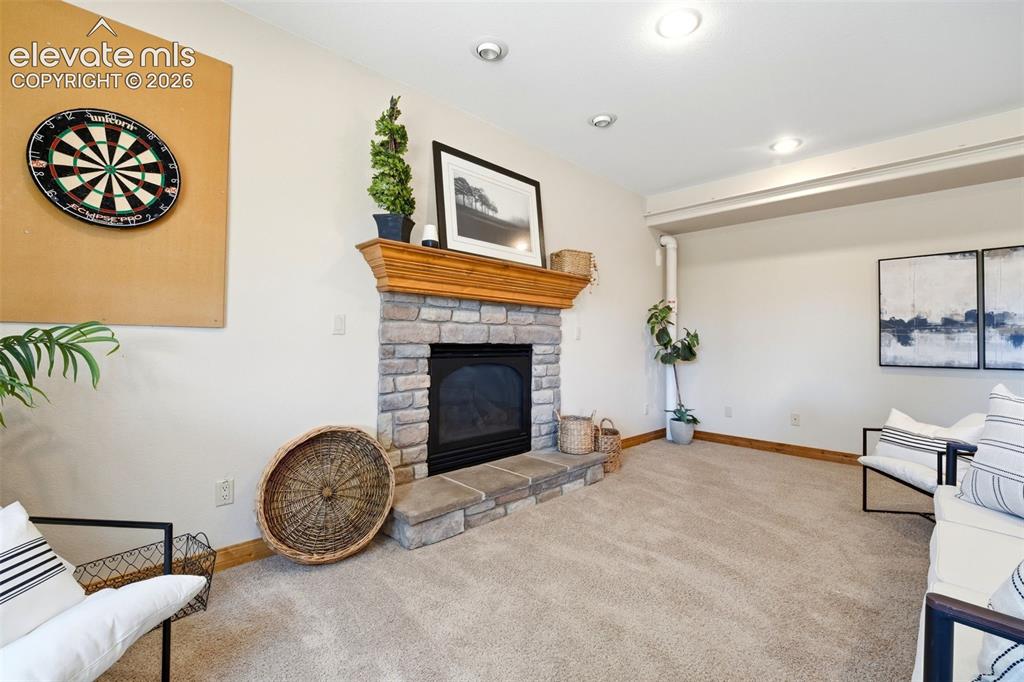 Image 23 of 50: Laundry area featuring extensive wood-finish cabinetry, a utility sink, and