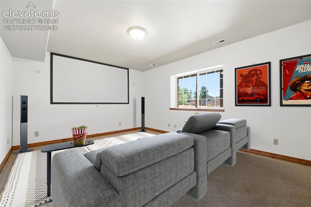 Image 30 of 50: Spacious room featuring light-toned carpet flooring, a window with natural 