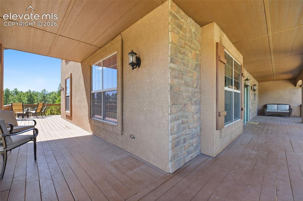 Image 37 of 50: Stone facade entry with a light green front door featuring decorative glass