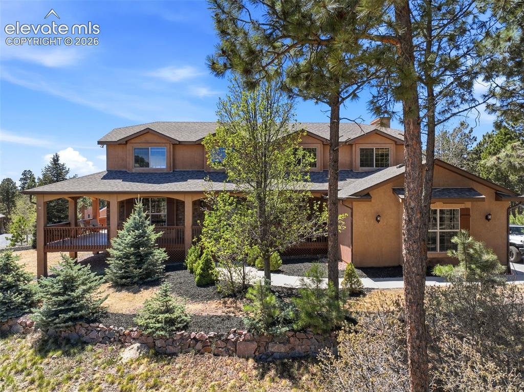 Image 38 of 50: Expansive residence featuring a multi-level design, covered front porch, an