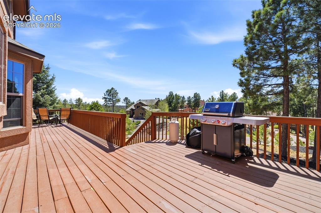 Image 40 of 50: Two-story property featuring stucco siding, a covered porch with wood raili