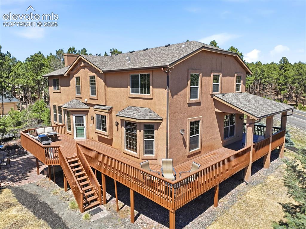 Image 42 of 50: Expansive outdoor deck featuring wood-finish flooring and sturdy wood raili