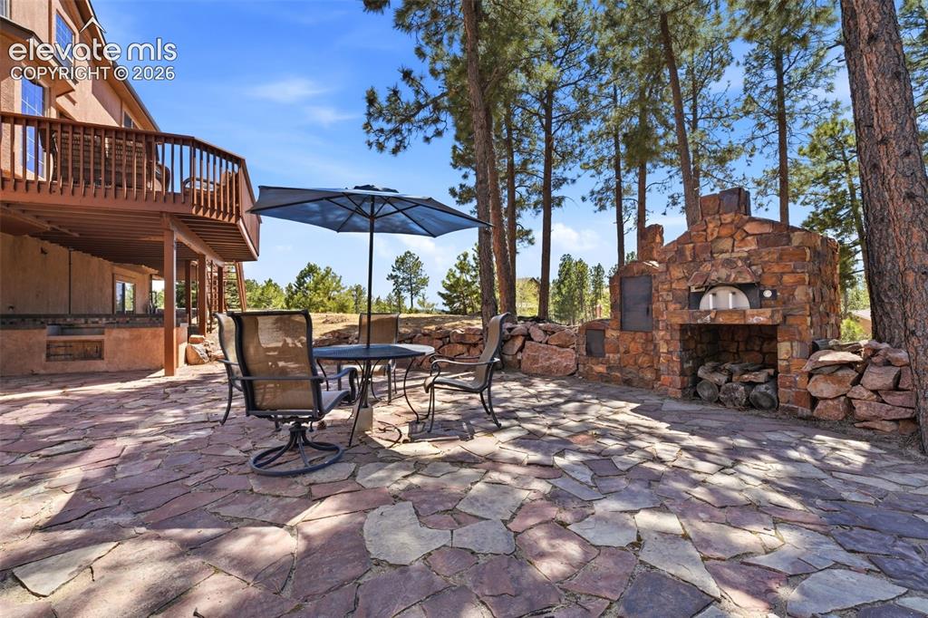 Image 43 of 50: Expansive outdoor deck with natural wood-tone decking and coordinating wood