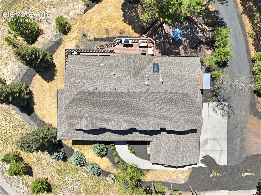 Image 47 of 50: Expansive flagstone patio featuring a stone outdoor fireplace, stone retain