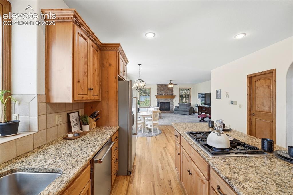 Image 5 of 50: Neutral wall paint with built-in shelving, a wooden door, and a ceiling fan