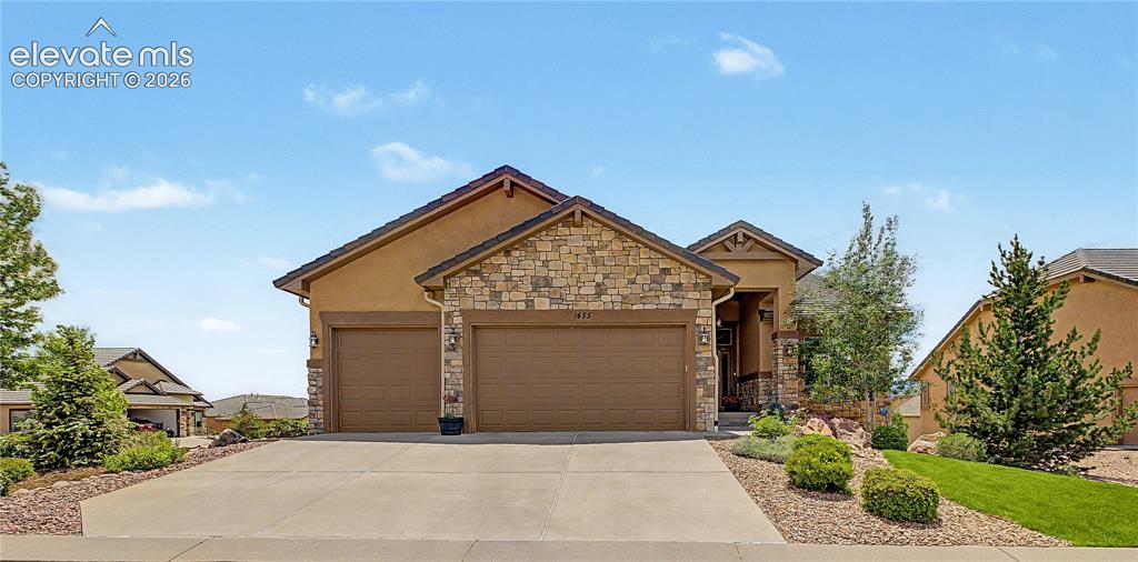 Image 1 of 49: Front view with a fully professionally landscaped lot!
