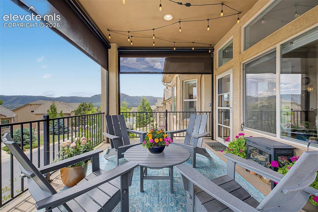 Image 10 of 49: Large, covered patio off the living room & dining area that has custom remo