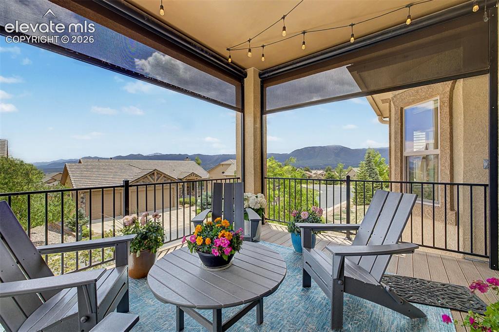 Image 11 of 49: Another view of the large patio with custom remote-controlled blinds with b