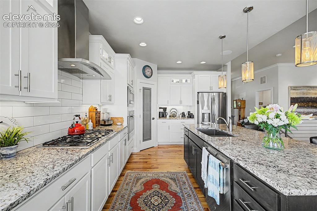 Image 14 of 49: Gas stove, custom vent and a coffee bar too!