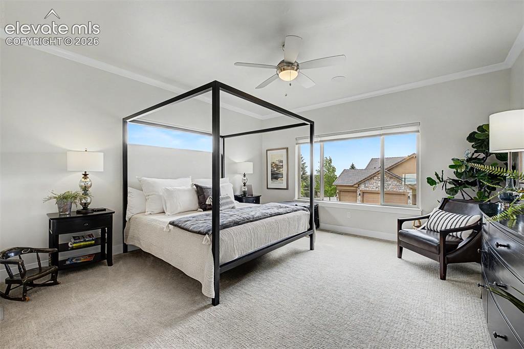 Image 20 of 49: Large spacious primary bedroom with top to bottom custom shades and upgrade