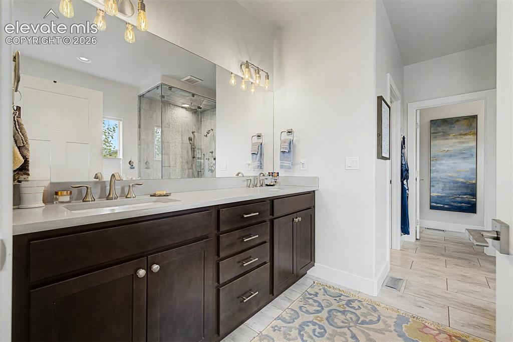 Image 25 of 49: Quartz countertops, double sinks, lots of cabinets, beautiful lighting and