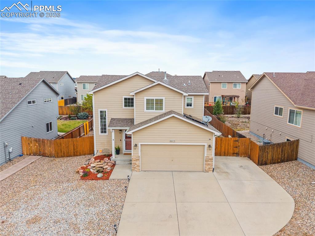 Image 1 of 43: Two-story residence featuring a two-car garage, stone accents, and a concre