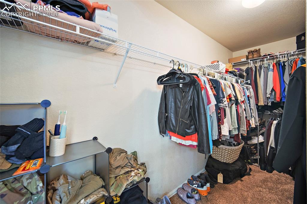Image 17 of 43: Closet space featuring wire shelving and hanging rods