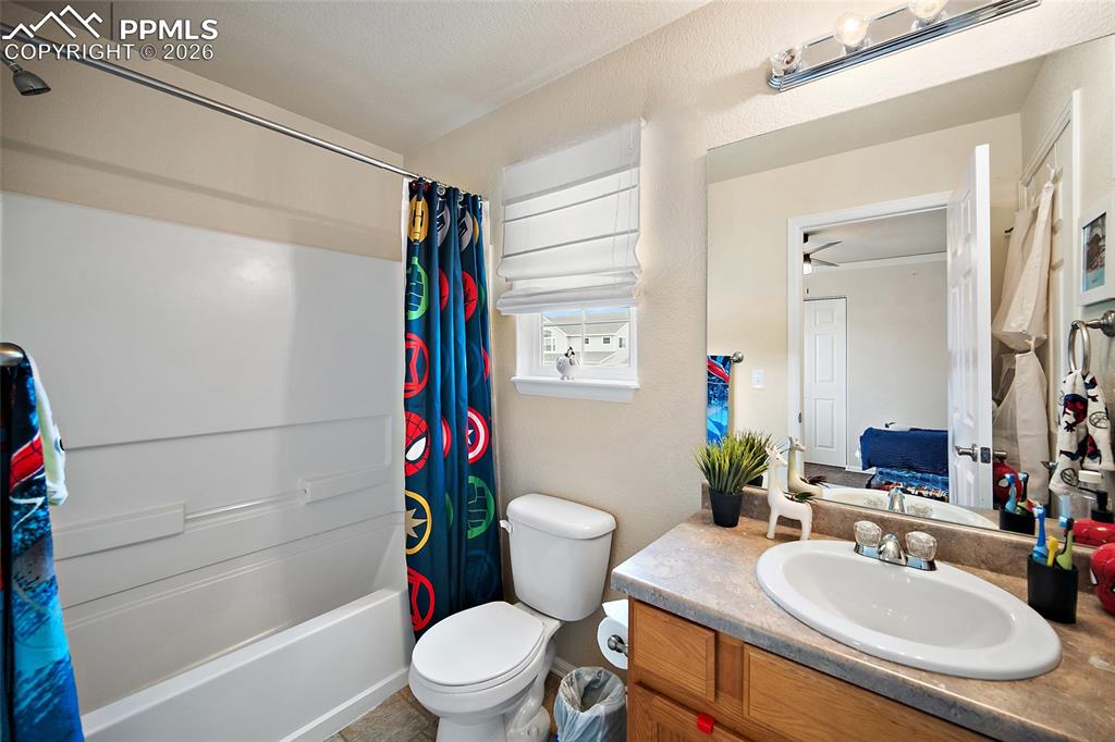 Image 24 of 43: Bathroom featuring a single vanity with an oval sink and a laminate counter