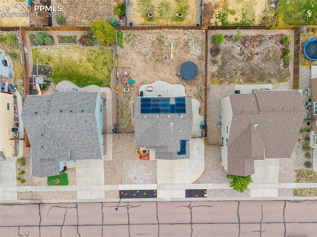 Image 28 of 43: Property features three distinct rooflines, paved driveways, and solar pane