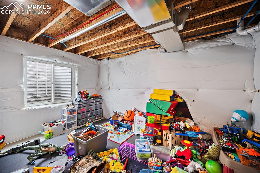 Image 29 of 43: Unfinished basement with exposed ceiling joists, visible ductwork, and whit