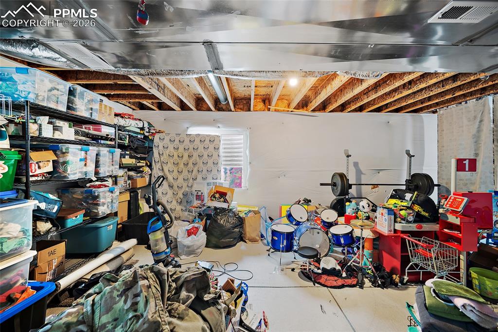 Image 30 of 43: Unfinished basement space featuring exposed ceiling joists, white painted w