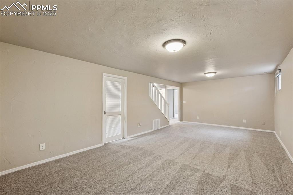 Image 21 of 37: Empty room with light carpet and a textured ceiling