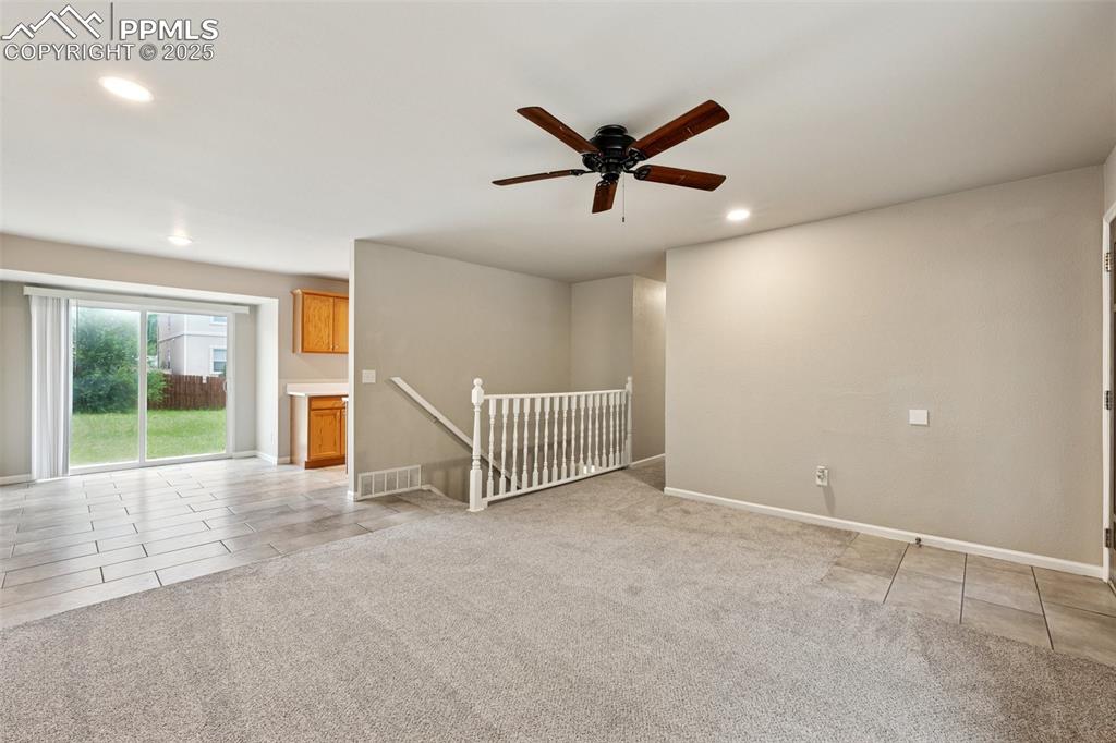 Image 6 of 37: Spare room featuring light tile patterned floors, light carpet, recessed li