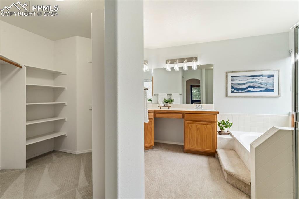 Image 19 of 39: Primary Bath + Closet View