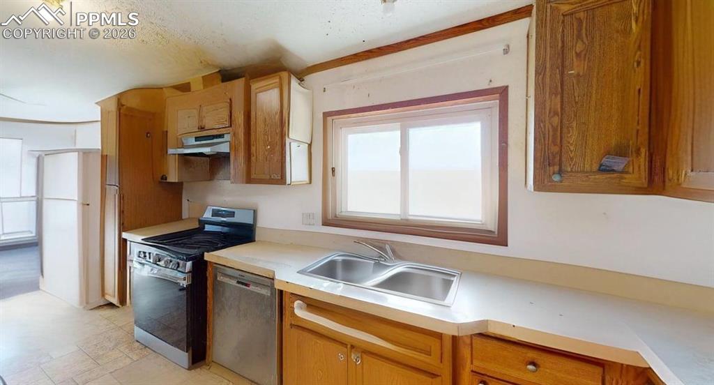 Image 15 of 31: Kitchen featuring stainless steel appliances, light countertops, ventilatio