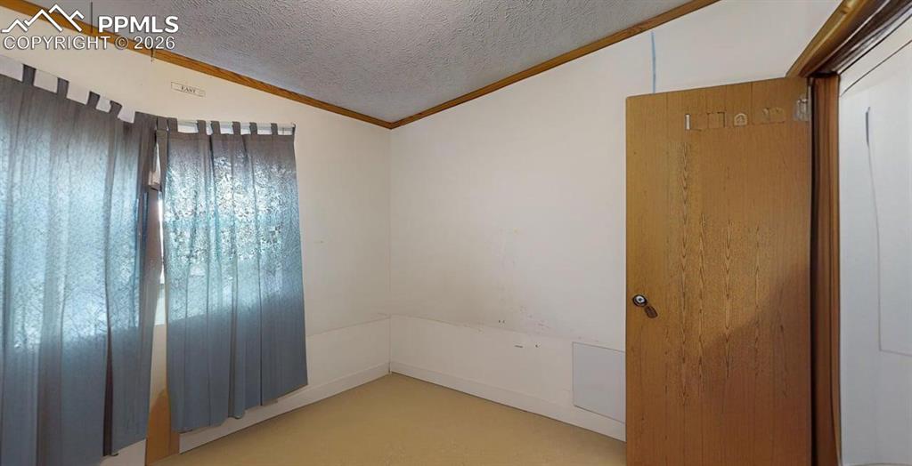 Image 21 of 31: Unfurnished room with ornamental molding and light colored carpet