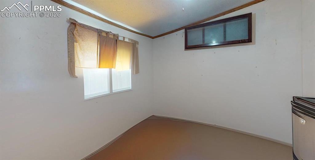 Image 25 of 31: Empty room featuring crown molding