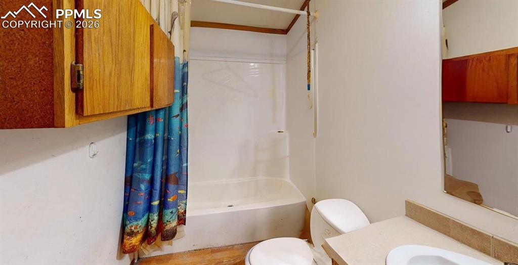 Image 27 of 31: Bathroom with vanity and shower / bath combination with curtain