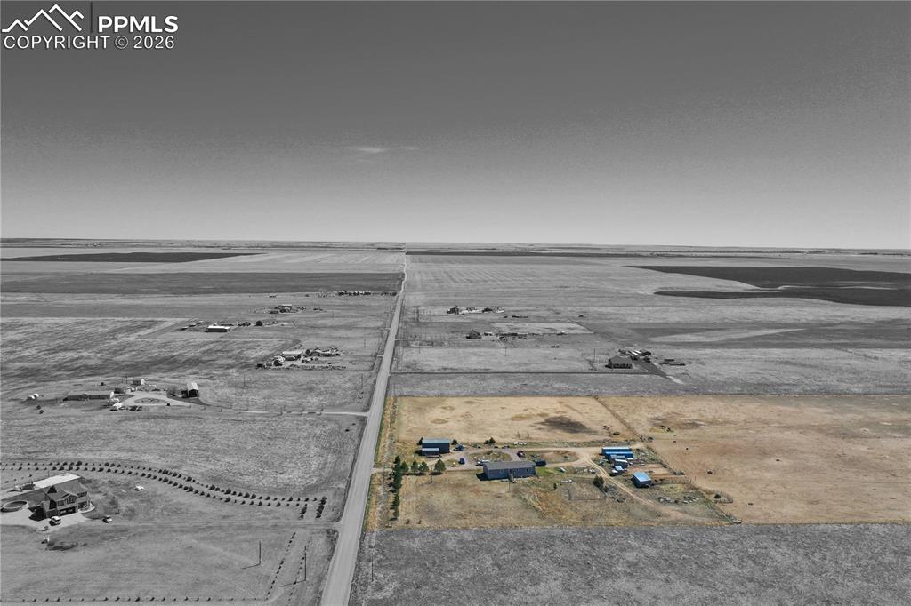 Image 7 of 31: Aerial view of sparsely populated area with large plots for crops