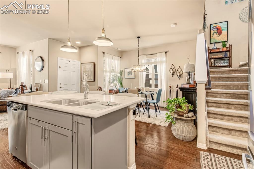Image 13 of 32: Open concept kitchen with island, breakfast bar, stainless steel appliances