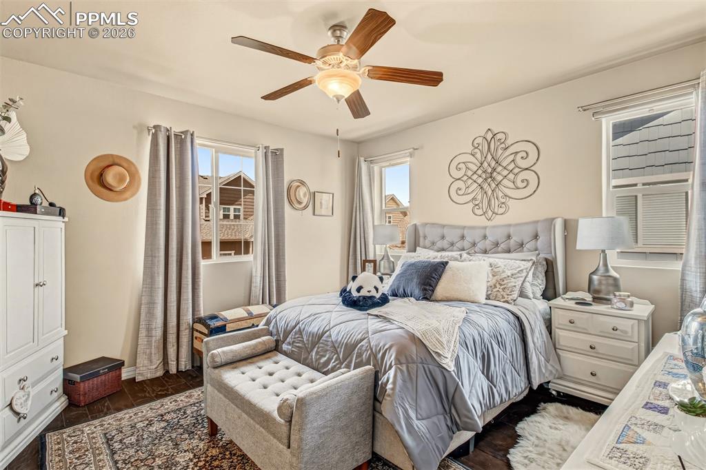 Image 16 of 32: Primary bedroom with en suite bathroom, walk in closet and views just outsi