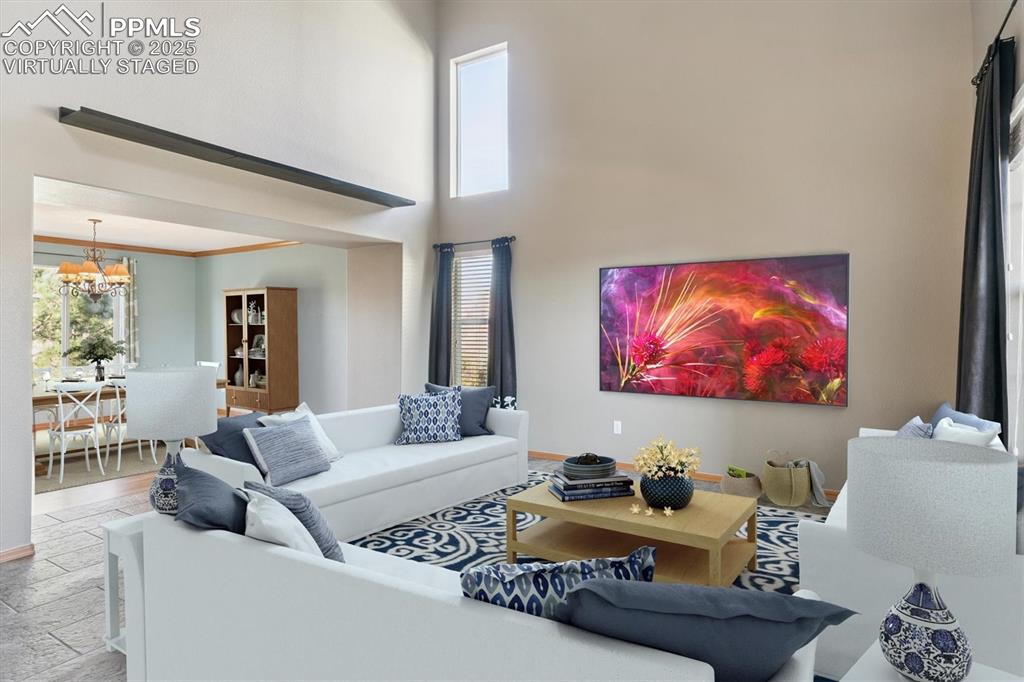 Image 12 of 45: Virtually staged, Living room with a towering ceiling, plenty of natural li