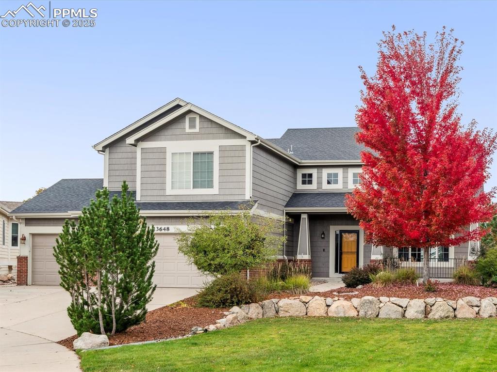 Image 2 of 45: Craftsman-style house featuring concrete driveway, a shingled roof, and an 