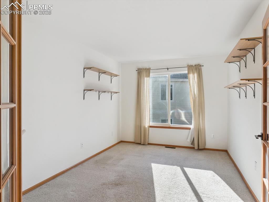 Image 24 of 45: Empty room with light carpet and baseboards