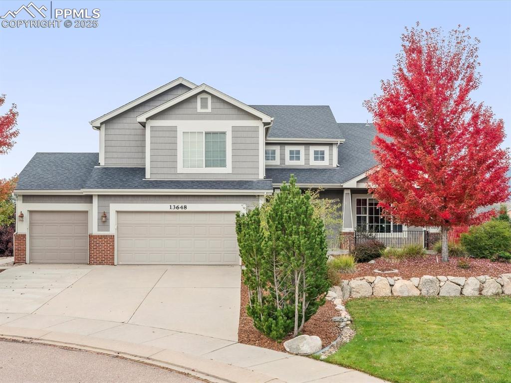 Image 3 of 45: Craftsman inspired home featuring driveway, brick siding, a garage, a shing