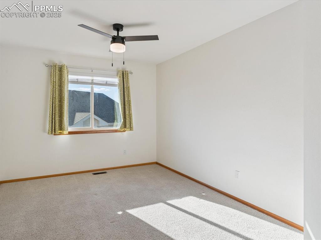 Image 33 of 45: Spare room with carpet flooring and a ceiling fan