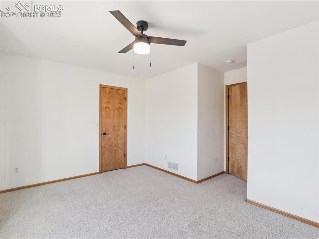 Image 36 of 45: Spare room featuring carpet floors and a ceiling fan