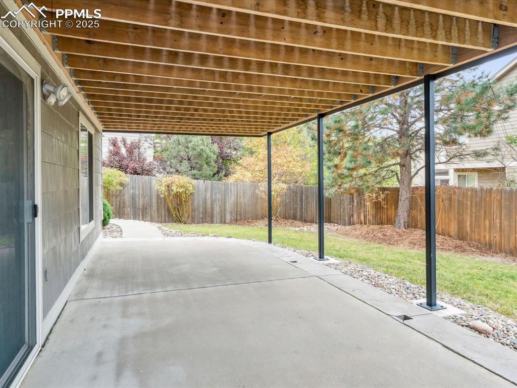 Image 6 of 45: Fenced backyard featuring a patio