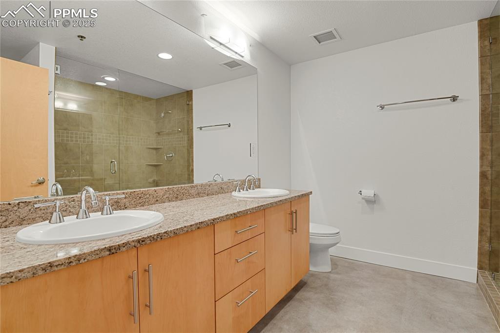 Image 26 of 42: Bath features large vanity, dual sinks, granite counters and large shower