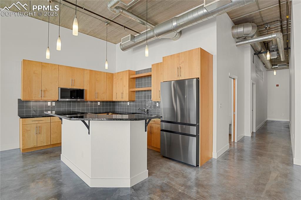 Image 7 of 42: Open kitchen with center island and bar seating