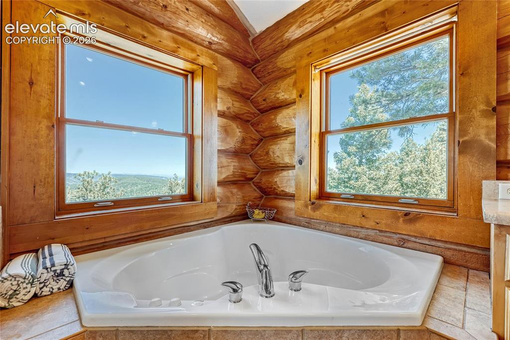 Image 10 of 33: Primary bedroom w/views to Pikes Peak