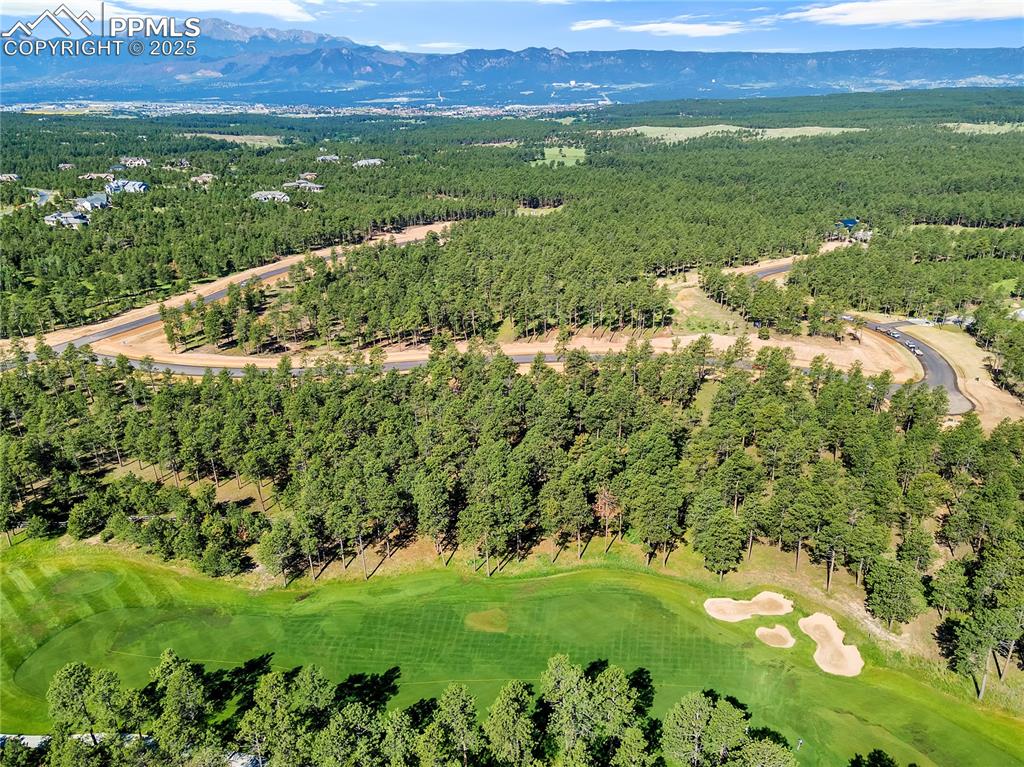 Image 7 of 9: View of property location with a golf course and mountains