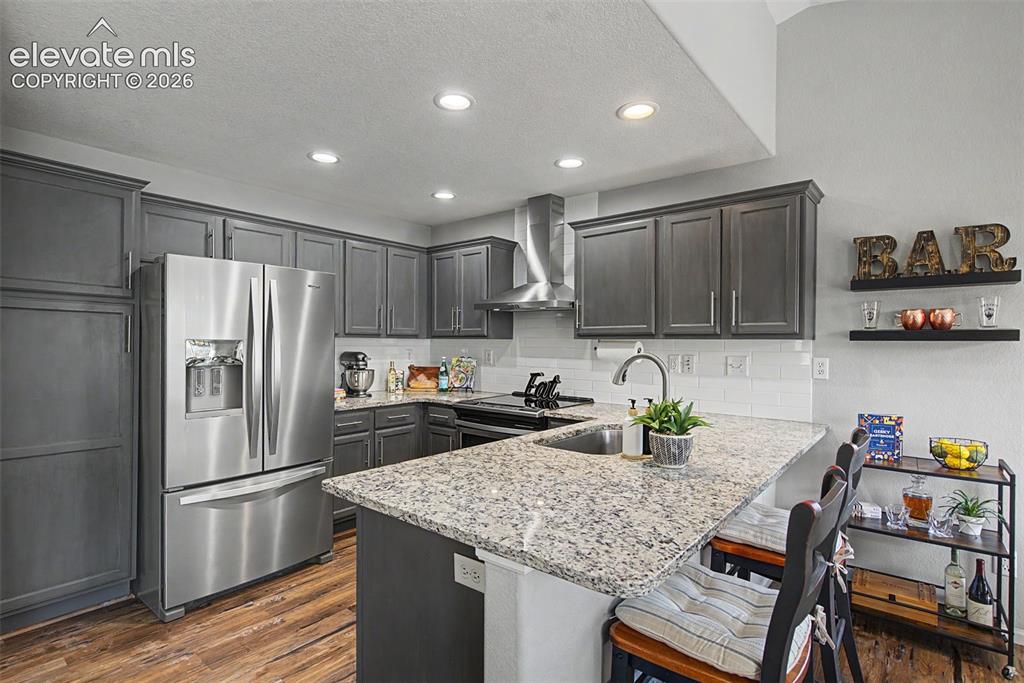 Image 18 of 48: Custom-painted cabinets and stainless appliances!