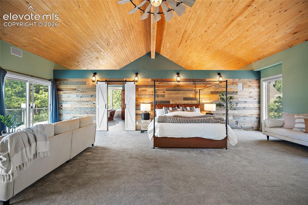 Image 17 of 50: Vaulted wood-finish ceiling with a ceiling fan