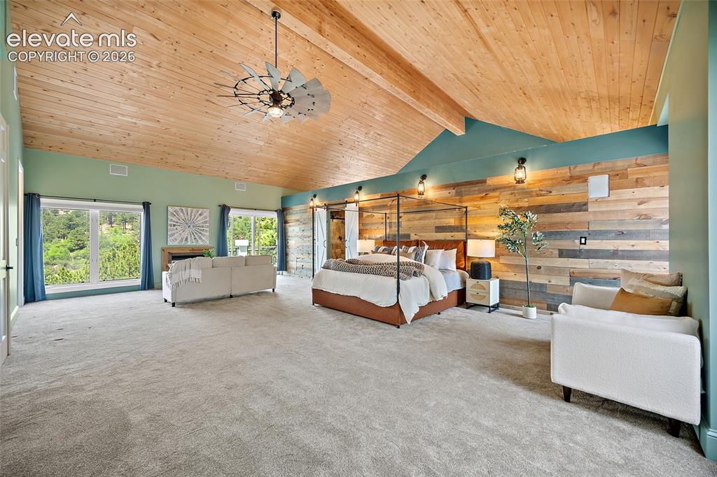 Image 18 of 50: Vaulted wood-paneled ceiling with exposed beams