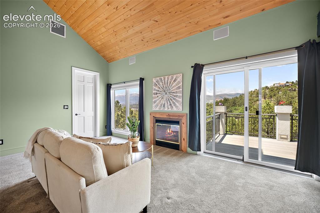 Image 19 of 50: Vaulted wood-paneled ceiling with light green walls